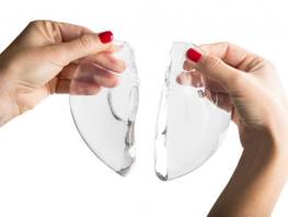 How does the body respond to breast implants?